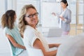 Casual businesswoman smiling at camera during meeting Royalty Free Stock Photo