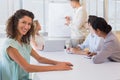 Casual businesswoman smiling at camera during meeting Royalty Free Stock Photo