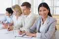 Casual businesswoman smiling at camera during meeting Royalty Free Stock Photo