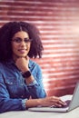 Casual businesswoman using laptop and smartwatch Royalty Free Stock Photo