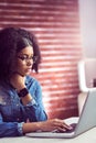 Casual businesswoman using laptop and smartwatch Royalty Free Stock Photo