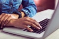 Casual businesswoman using laptop and smartwatch Royalty Free Stock Photo