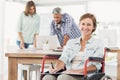 Casual businesswoman in wheelchair with notepad Royalty Free Stock Photo