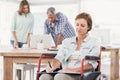 Casual businesswoman in wheelchair taking notes Royalty Free Stock Photo