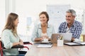 Casual businesswoman in wheelchair talking to colleagues Royalty Free Stock Photo