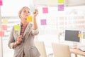 Casual businesswoman writing on sticky notes Royalty Free Stock Photo