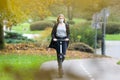 Casual caucasian teenager wearing protective face mask riding urban electric scooter in city park during covid pandemic Royalty Free Stock Photo