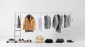 Casual clothing on a wooden clothes rack. Coat, shirts, shoes, bag, on white background with copy space. Generative AI