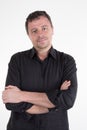 Confident handsome man keeping arms crossed and smiling standing against white background Royalty Free Stock Photo