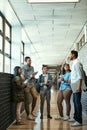 Casual conversations on campus. Full length shot of a group of university students talking while standing in a campus Royalty Free Stock Photo