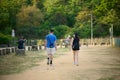 Casual couple enjoying a leisurely stroll through a picturesque park in Hong Kong