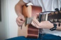 Casual day of a young singer who trains various guitar holdings and chords to improve his skills. Playing an instrumental