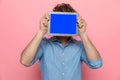 Casual denim guy covering face with tab Royalty Free Stock Photo