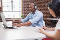 Casual designer working at his desk Royalty Free Stock Photo