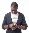 Casual dressed black man looking his mobile phone.