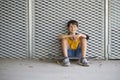 Casual dressed young smiling teen skater outdoors portrait