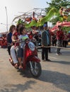 Casual family pass by the procession of Sihanoukville annual Carnival