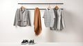 Casual female clothing on a metal clothes rack. Shirts, shoes, and scarf on hangers, on white background. Generative AI