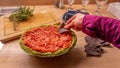 Casual girl dipping into Mexican salsa dip while holding nacho tortillia chips Royalty Free Stock Photo