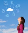 Casual girl looking at cloud computing concept on blue sky Royalty Free Stock Photo