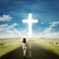 Casual girl walking toward a cross Royalty Free Stock Photo