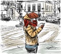 Casual girl in warm winter clothes standing on street at intersection and looking her smartphone. City people Royalty Free Stock Photo