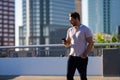 Casual handsome man chatting on phone in urban city. Well-dressed man talking on phone outdoor. Businessman using phone Royalty Free Stock Photo