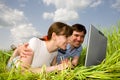 Casual happy couple on a laptop computer