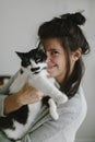 Casual happy  woman hugging cute cat in stylish modern room. Sweet authentic home moments Royalty Free Stock Photo
