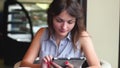 Casual happy young woman using her tablet. girl in a cafe with a tablet