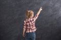 Casual little girl showing finger up at gray background Royalty Free Stock Photo