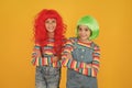 Casual but luxury. Casual party look of little children. Small girls wear colored hair wigs in casual denim style. Happy