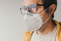 Casual male wearing eyeglasses and protective respiratory KN95 face mask during covid-19