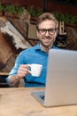 Casual man drinking coffee and looking at camera happy Royalty Free Stock Photo