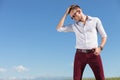 Casual man fixes his hair outdoors Royalty Free Stock Photo