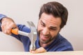 Casual man hammering his finger by accident Royalty Free Stock Photo