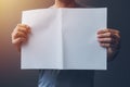 Casual man holding blank A3 paper spread as copy space Royalty Free Stock Photo