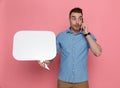 Casual man holding speech bubble and talking on the phone Royalty Free Stock Photo