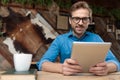 Casual man holding tablet while looking at camera happy Royalty Free Stock Photo