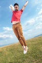 Casual man jumps with hands in air Royalty Free Stock Photo