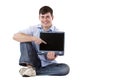 Casual man with laptop pointing at copy-space