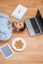 Casual man lying on floor surrounded by his possesions Royalty Free Stock Photo