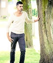 Casual man outdoors leaning on a tree Royalty Free Stock Photo