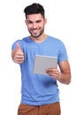 Casual man reading good news on his tablet pad Royalty Free Stock Photo