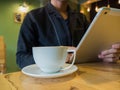 Casual man relaxed using digital tablet with coffee cup