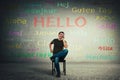 Casual man seated on a chair talking on mobile phone. Happy manager speaking different languages with his clients Royalty Free Stock Photo