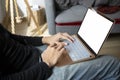 Man sitting on couch and surfing internet with laptop. Royalty Free Stock Photo