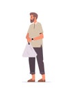 casual man with smart watch holding shopping plastic bag while walking vertical full length