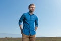 Casual man standing with hands in back pocket looking ahead Royalty Free Stock Photo