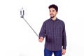Casual man using a selfie stick Royalty Free Stock Photo
